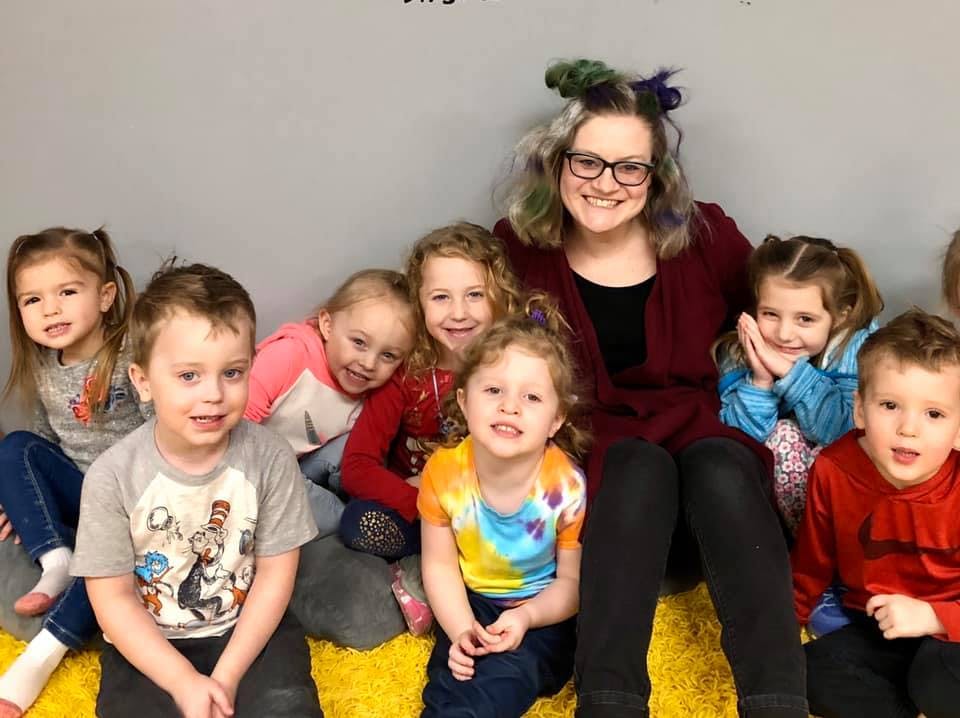 Adult and multiple children sitting together