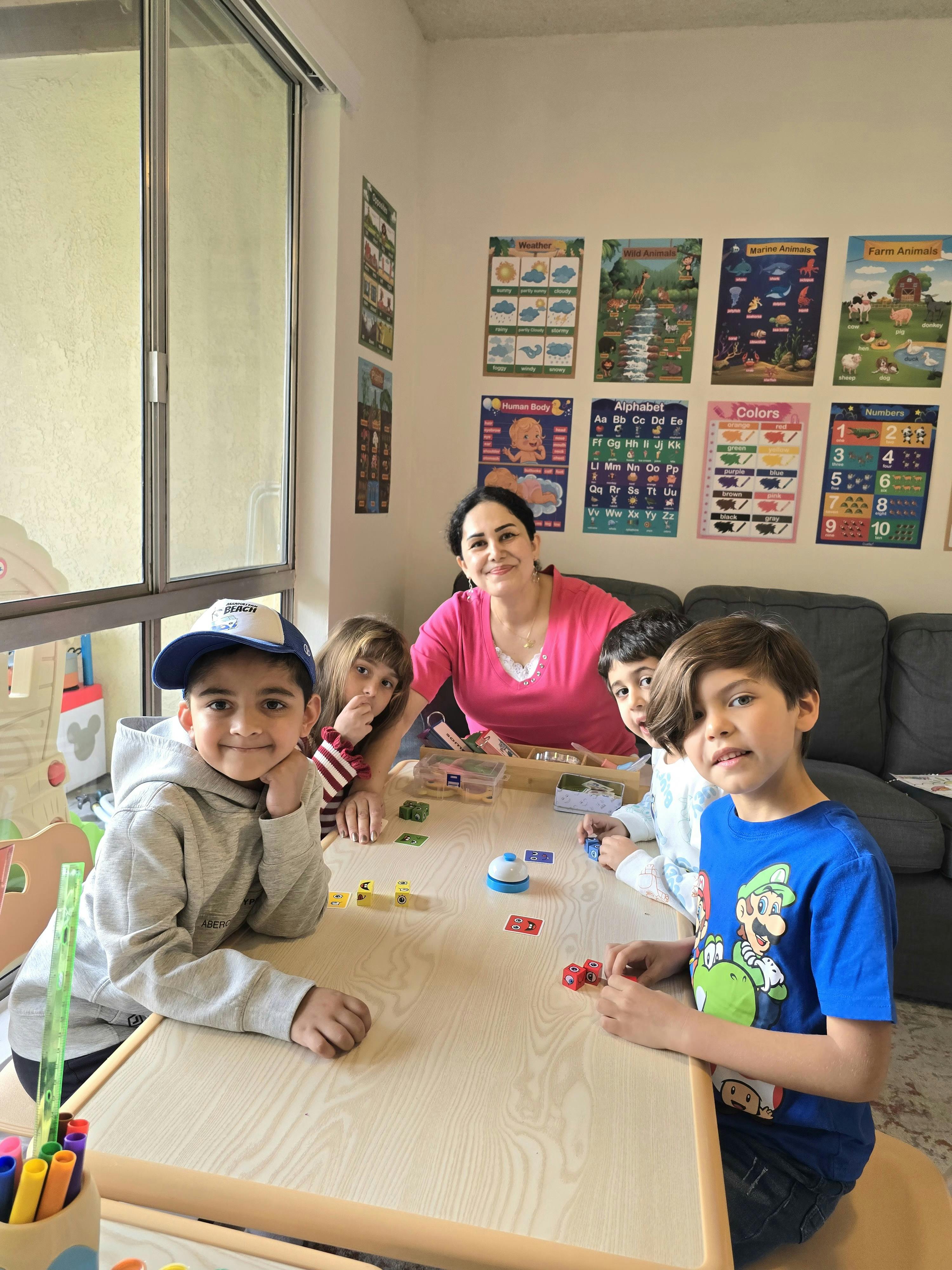 Adult and multiple children sitting around a table with small objects