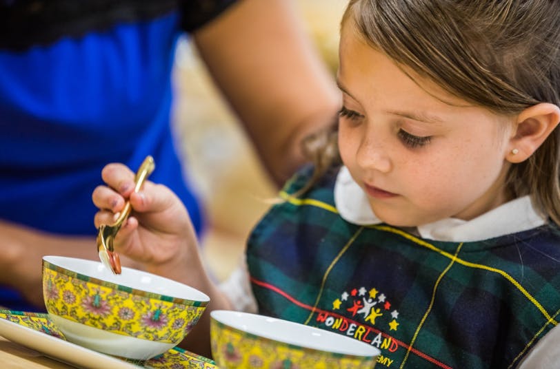 Child eating from a bowl with a spoon