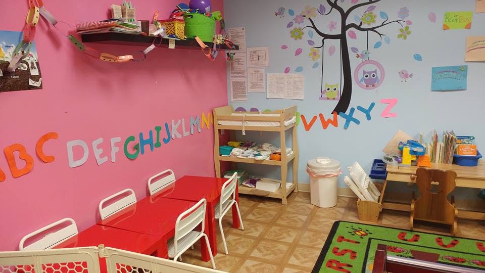 Children's classroom with alphabet letters on walls and small tables