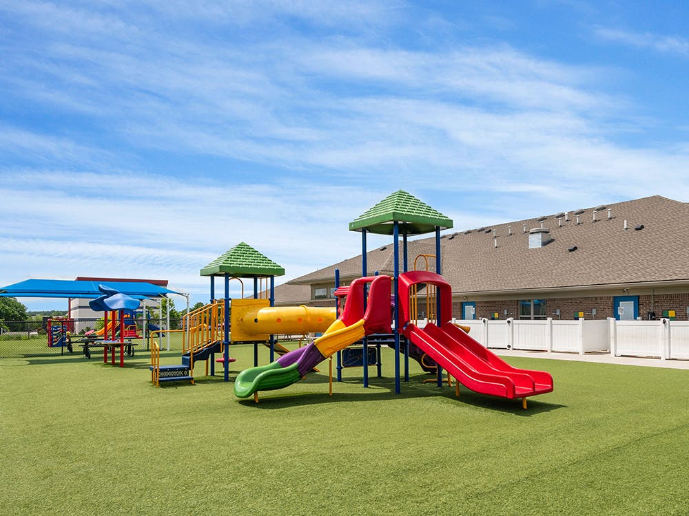Colorful playground with multiple slides and climbing structures