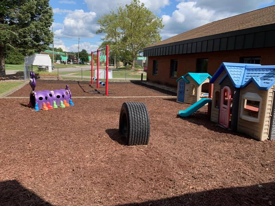 Playground with playhouses, tire, and climbing structure