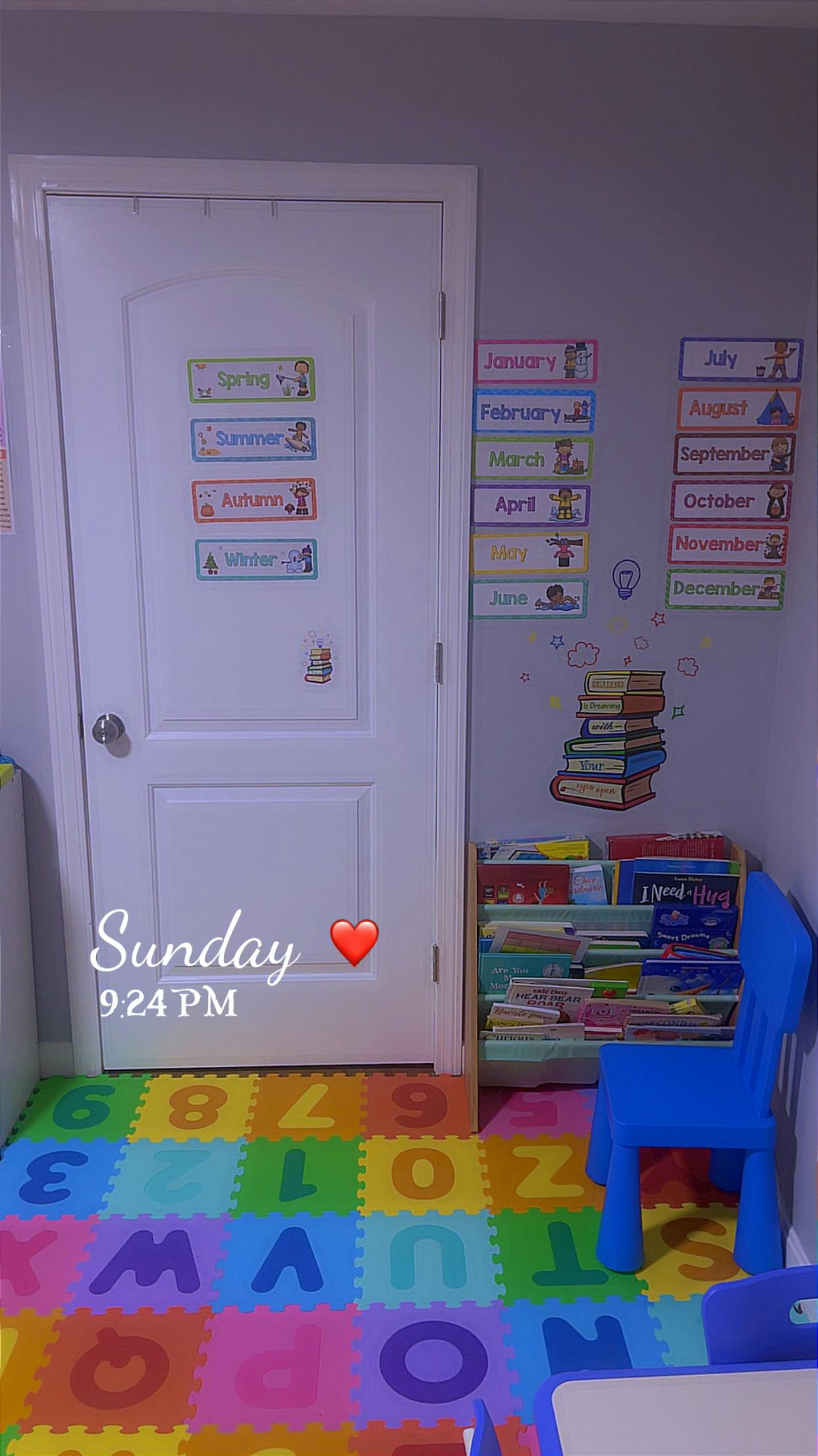 Door with seasons and months charts, book display, and alphabet floor mat