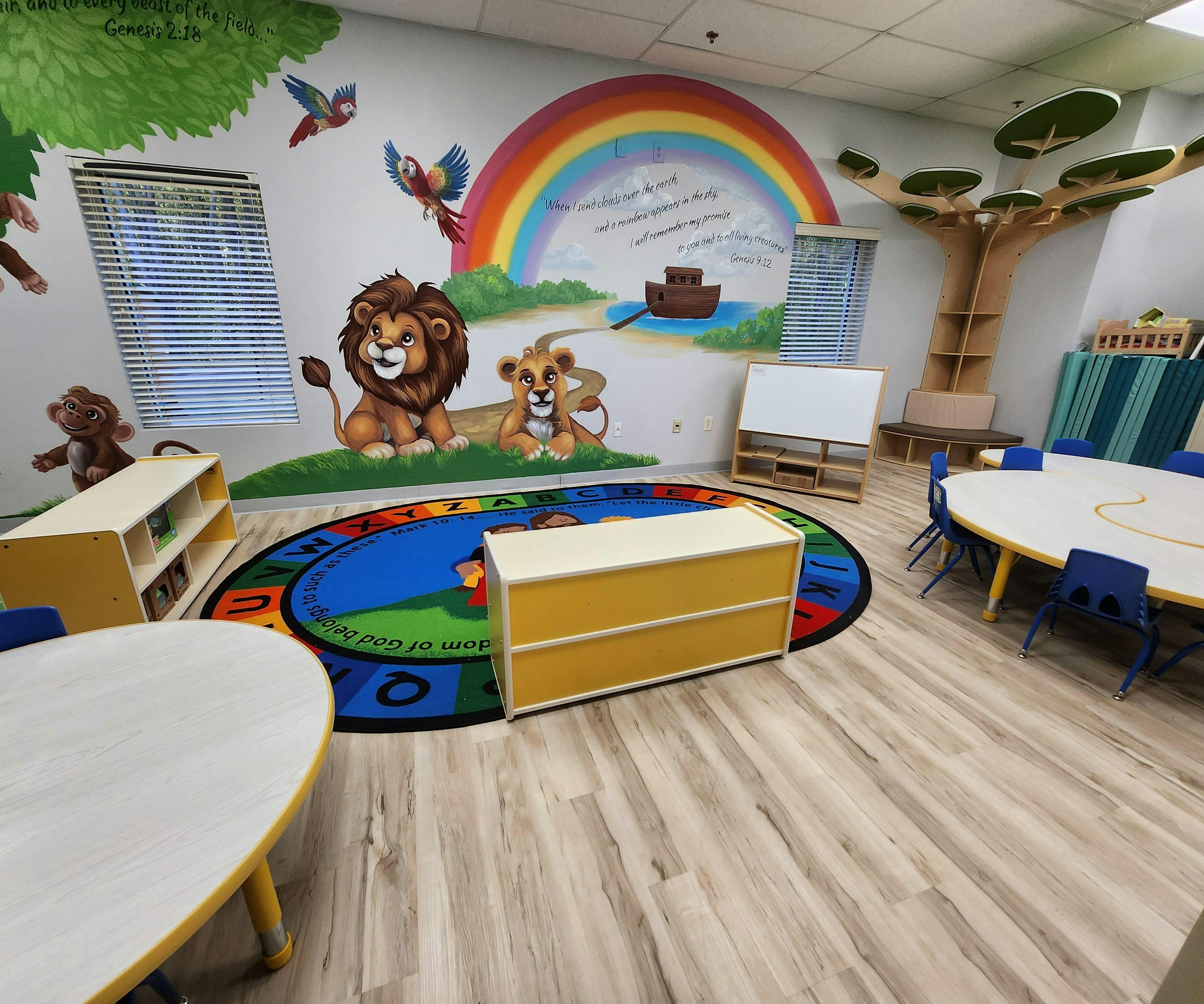 Classroom with colorful wall mural of lions and a rainbow