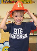 Child wearing a firefighter hat