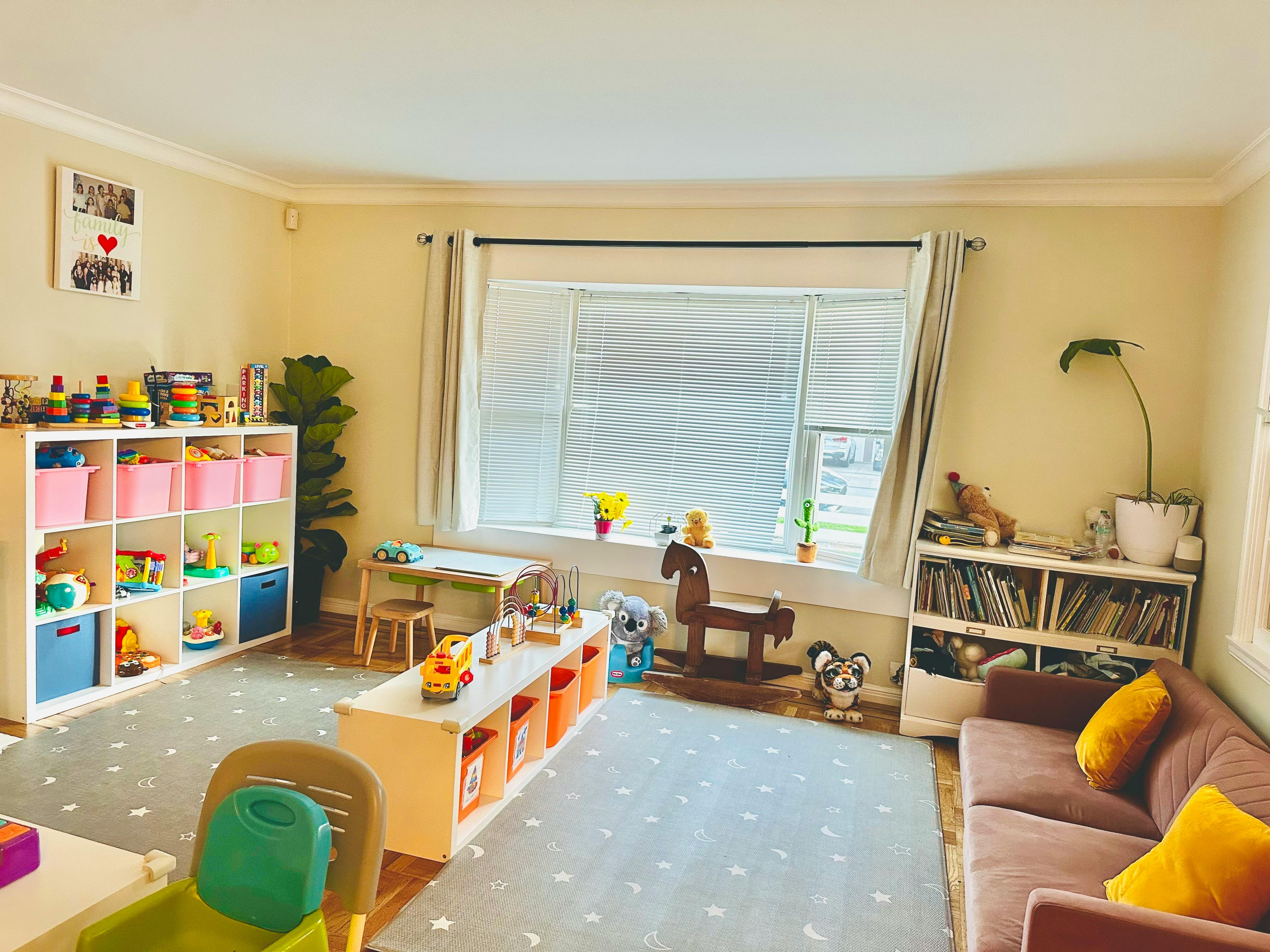 Playroom with toys, shelves, small table and chairs, and a rocking horse