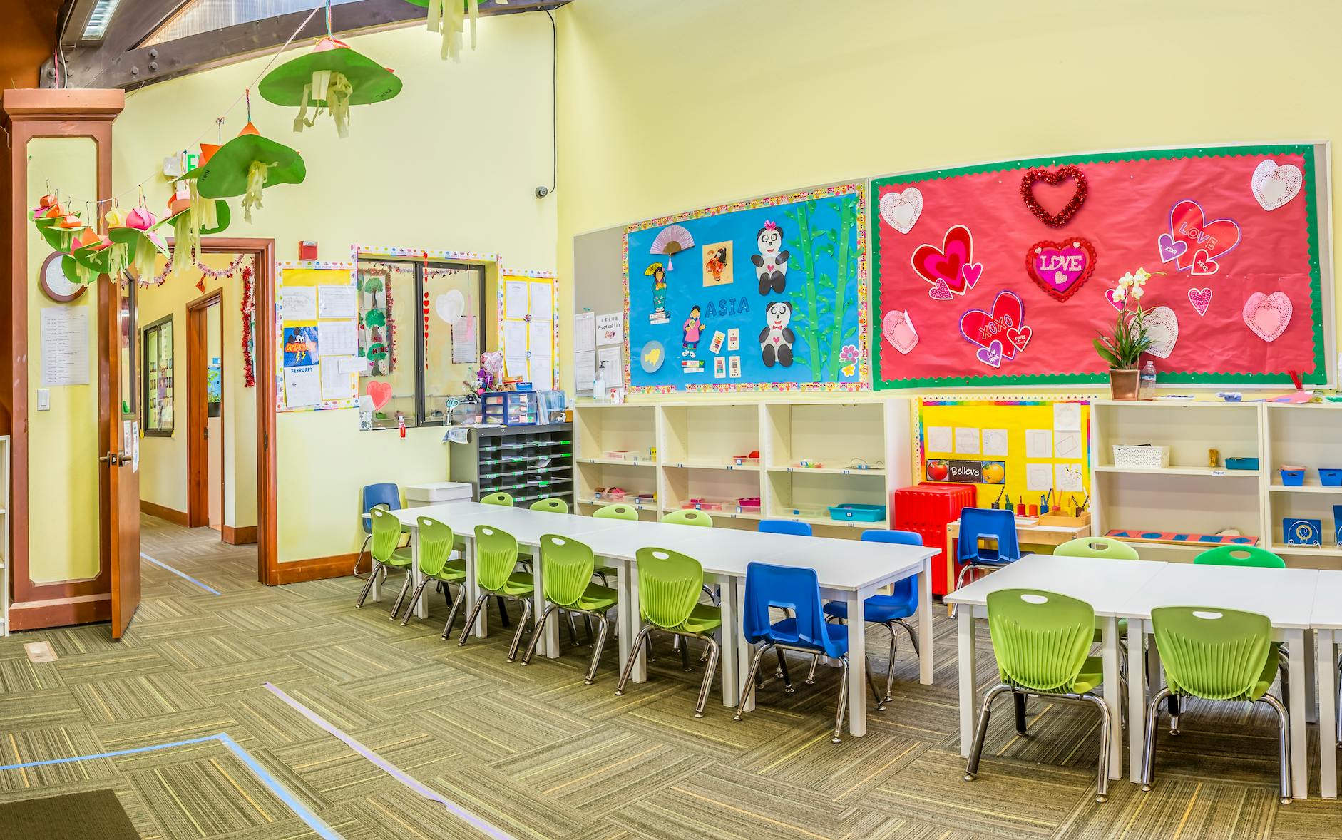 Classroom interior with tables, chairs, and themed wall decorations
