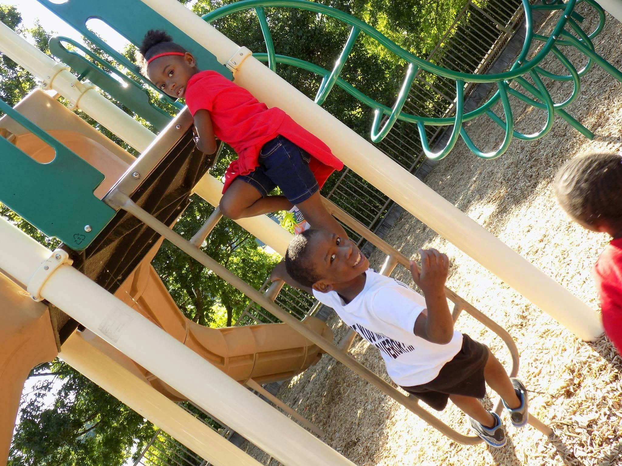 Two children on playground equipment
