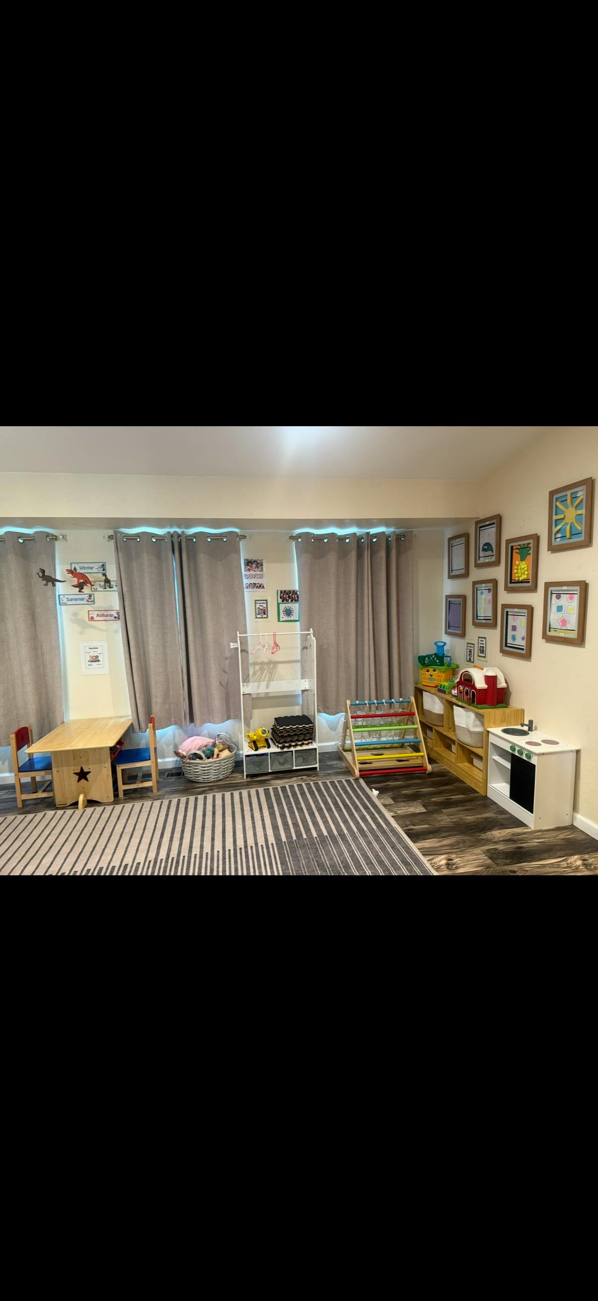 Childcare room with small tables, storage shelves, and play equipment