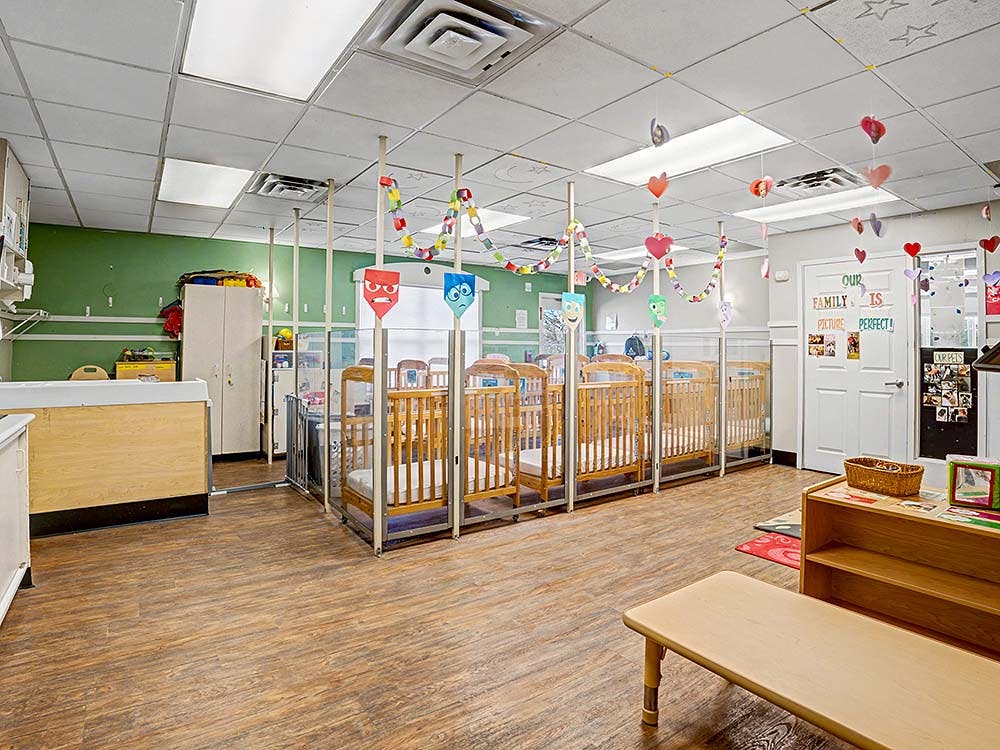 Classroom with multiple cribs separated by clear partitions