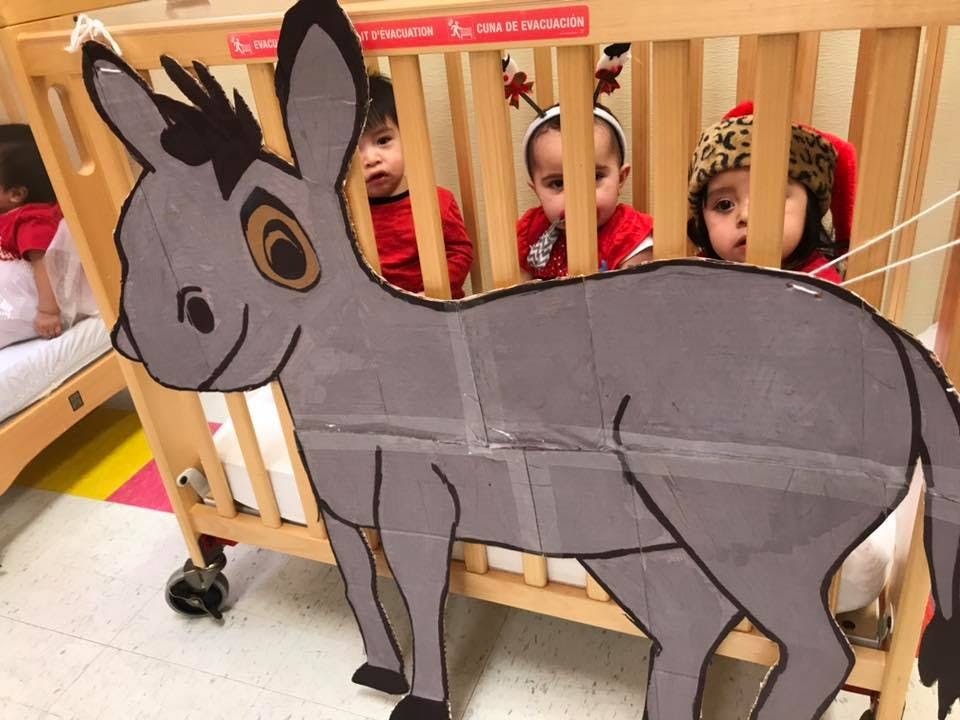 Cardboard donkey in front of children in cribs