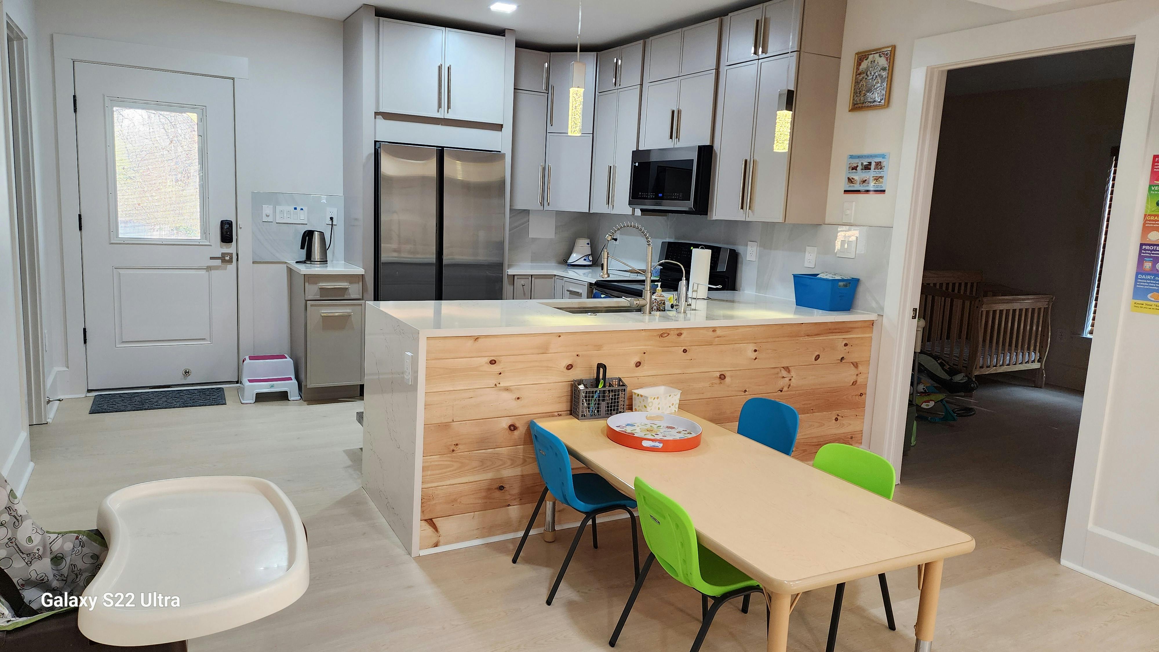 Kitchen with a small table and colorful chairs