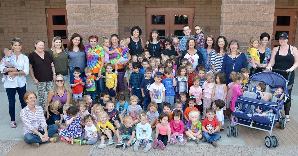 Large group of adults and children posing outdoors