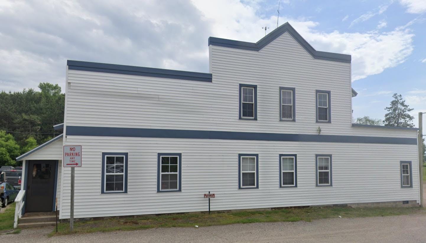 White building with dark trim and multiple windows