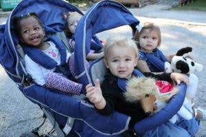 Four children in a large stroller