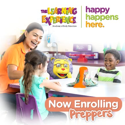 Adult and two children at a table with a toy lion and volcano