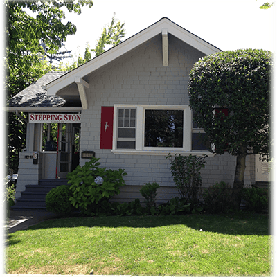 Small house with a porch and a sign that reads "STEPPING STON"