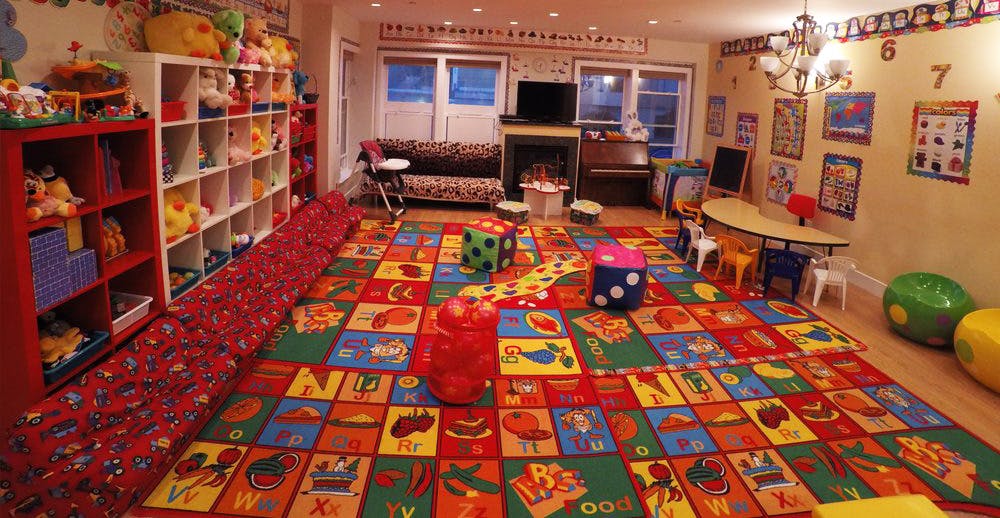 Playroom with colorful alphabet rug and toys