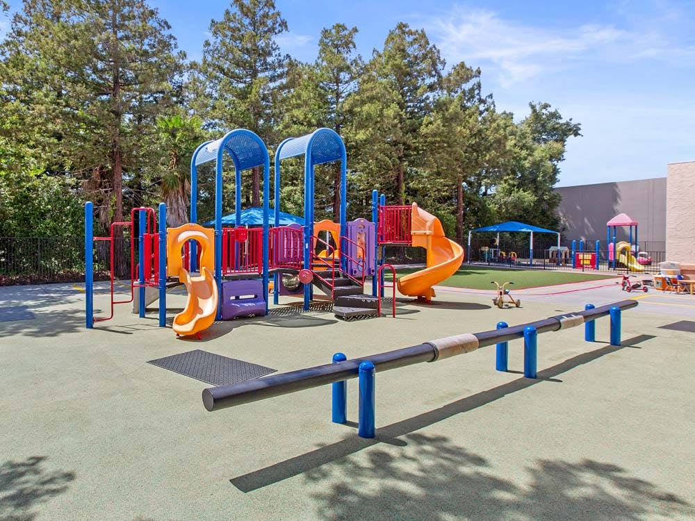Colorful empty playground with slides, swings, and other play structures