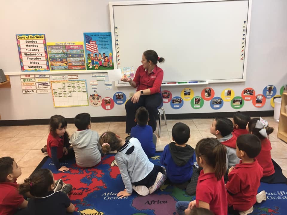 Adult reading to children in a classroom