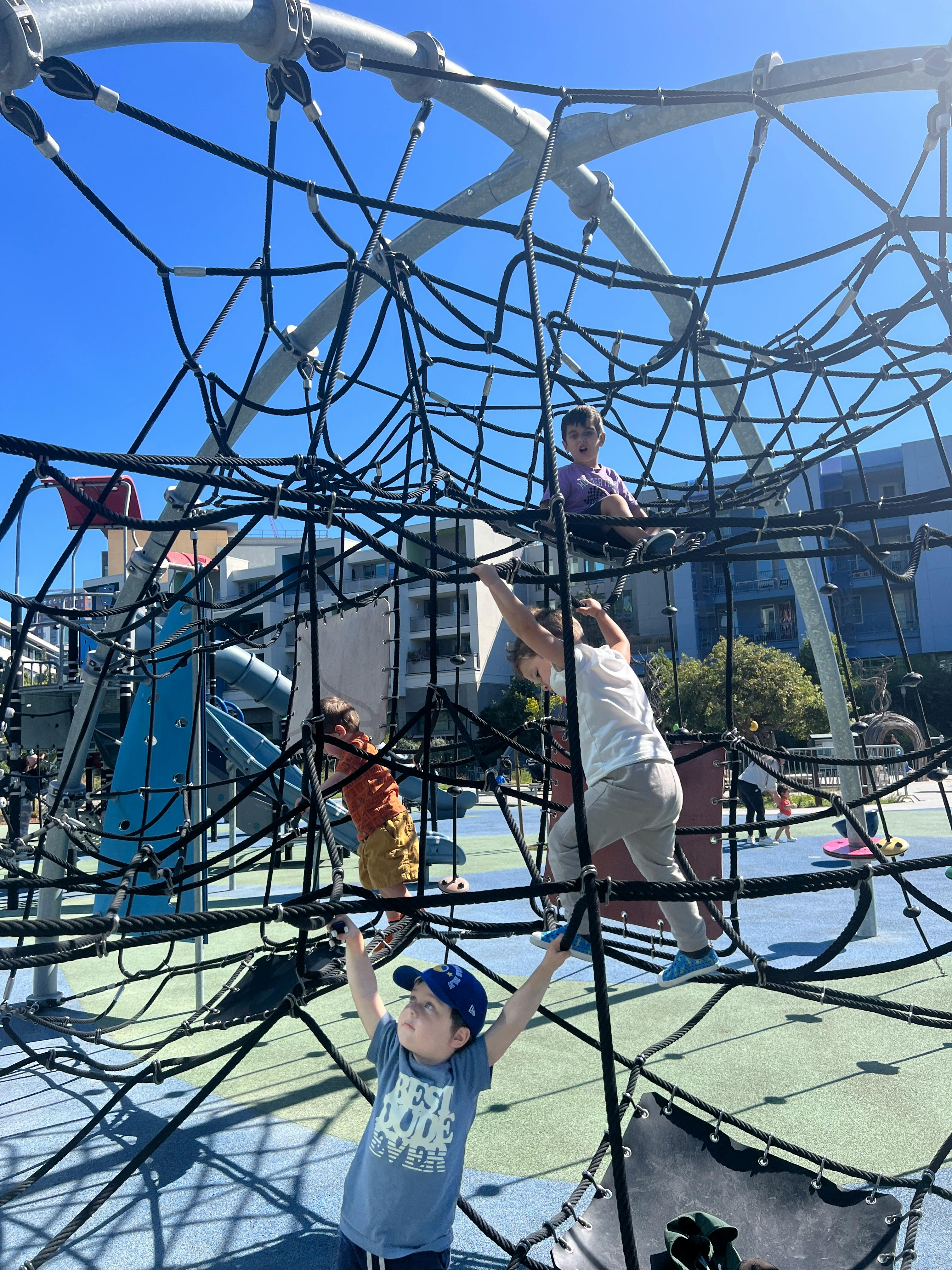 Children climbing on a rope playground structure
