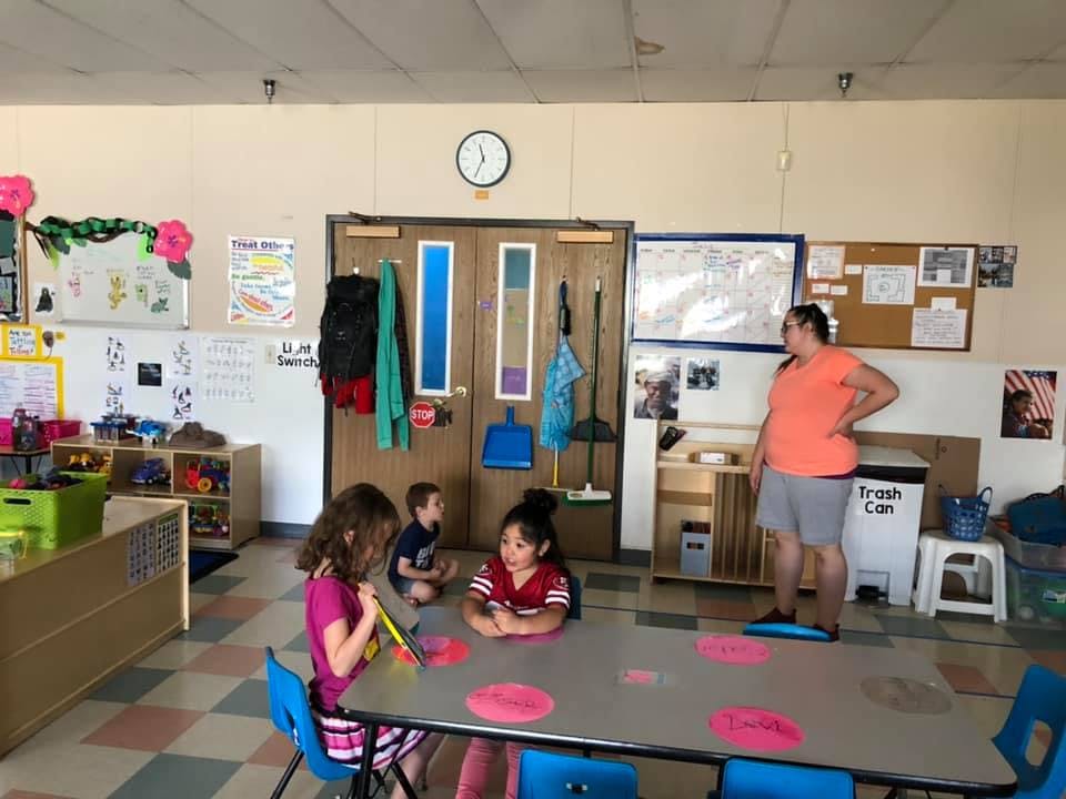 Adult and children in a classroom