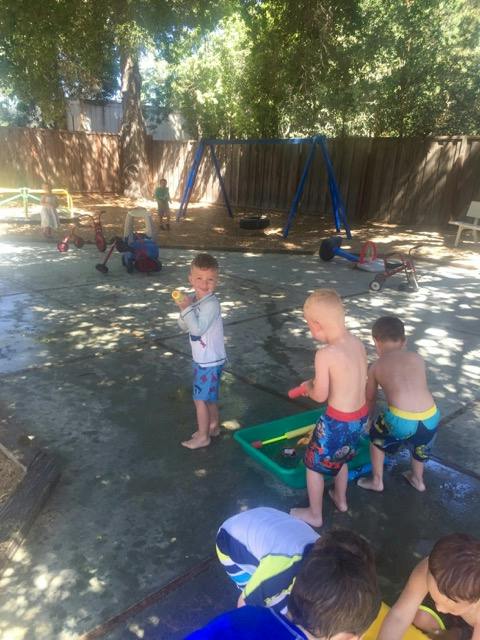 Children playing with water toys outdoors