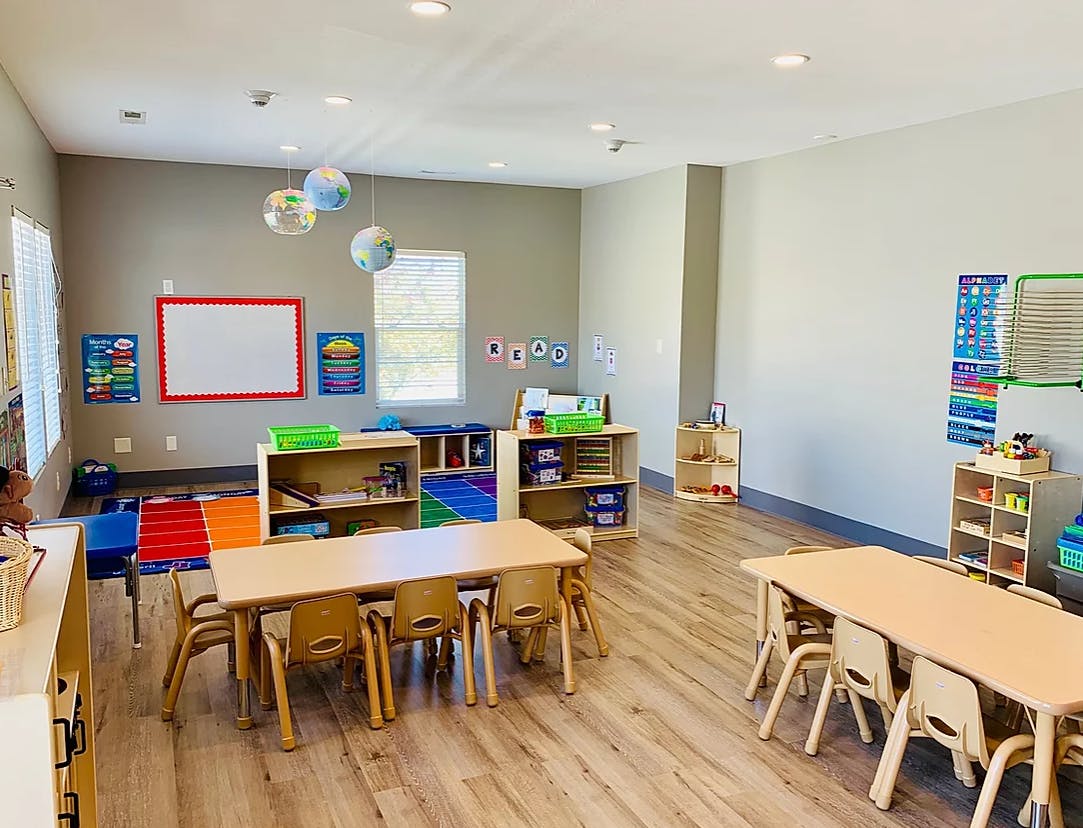 Empty classroom with small tables and chairs