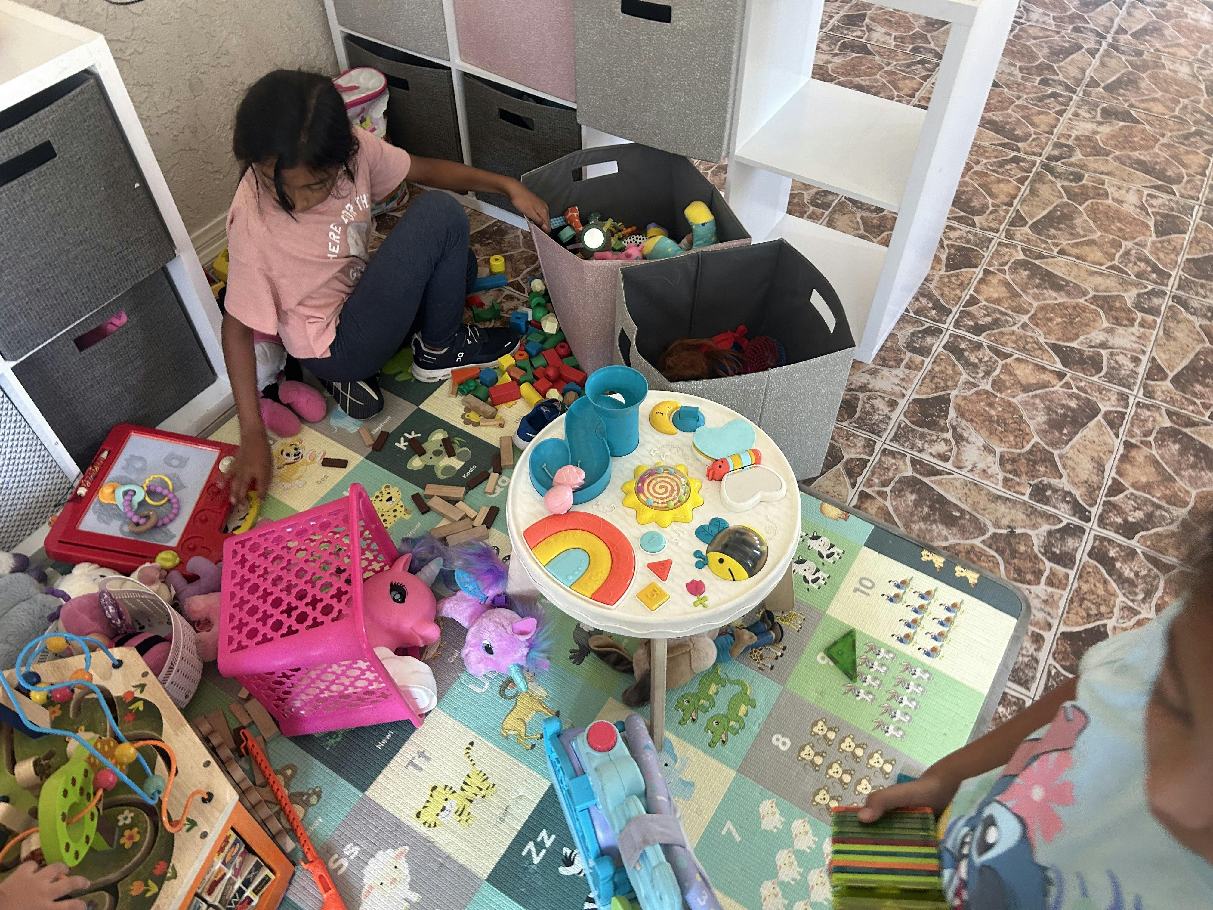 Child playing with toys on a mat
