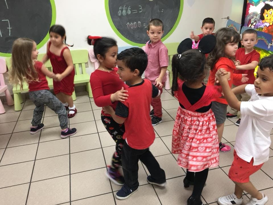 Children dancing in a classroom