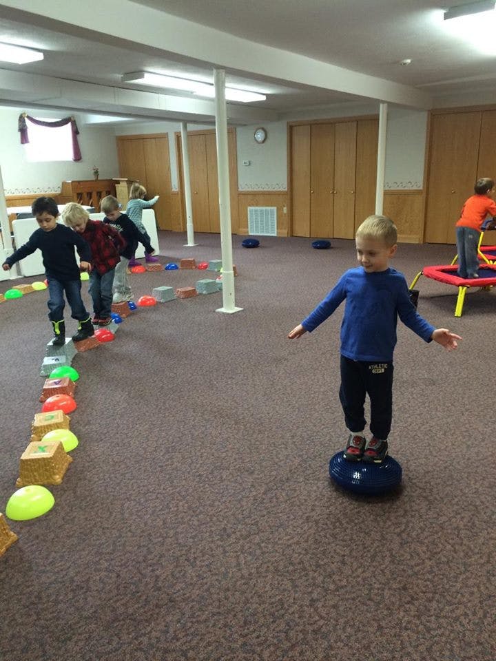 Children playing on an indoor obstacle course