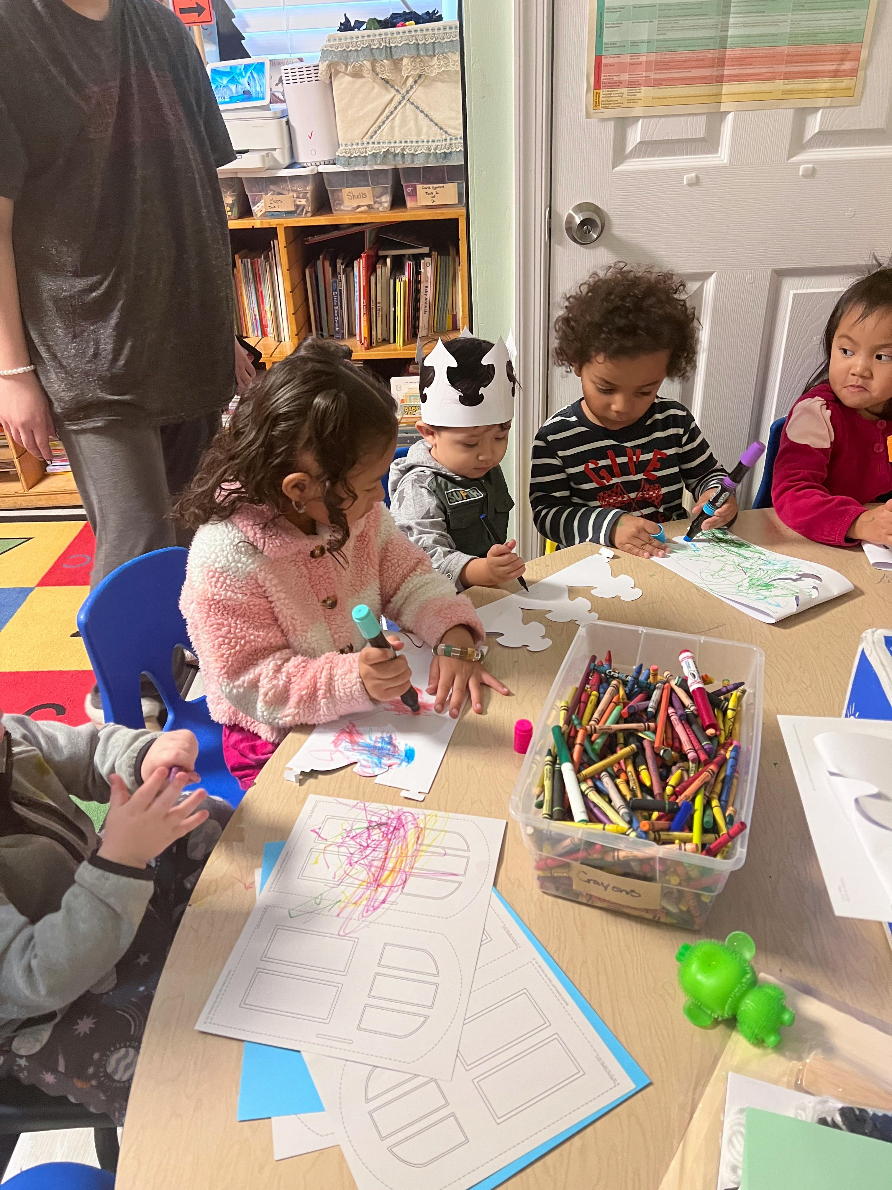 Children drawing and coloring at a table