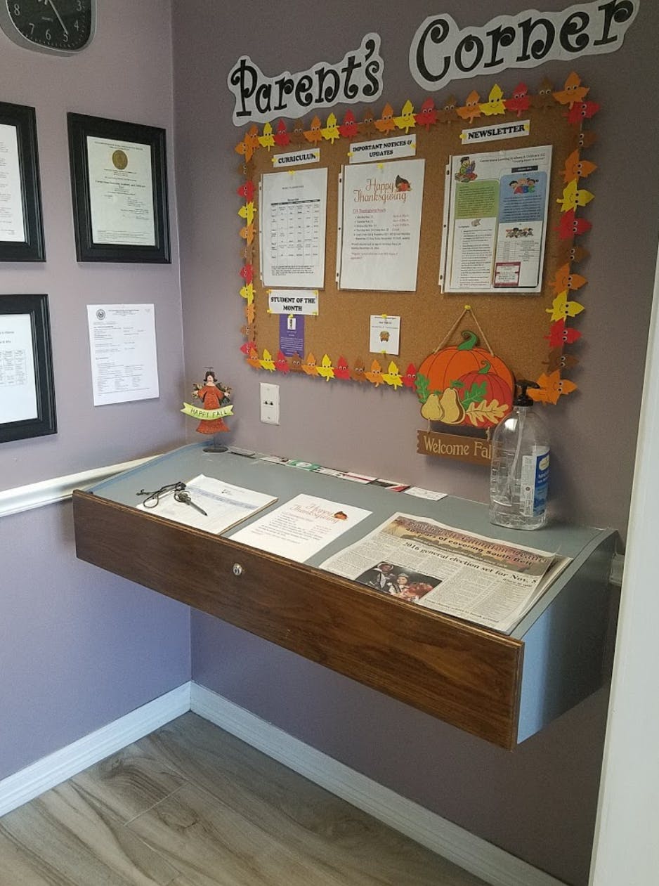 Bulletin board with "Parent's Corner" sign above a floating desk