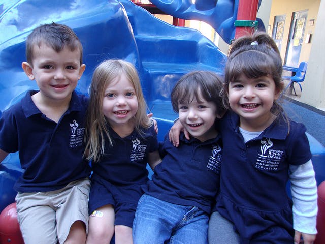 Four children in uniform sitting together