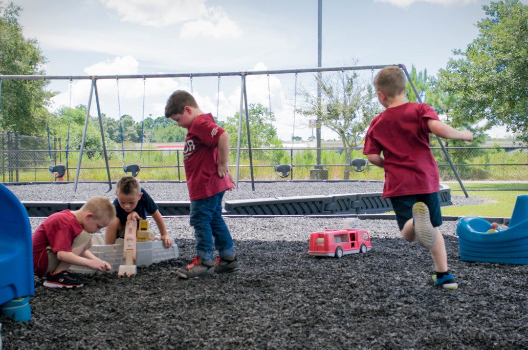 Three children playing on a playground