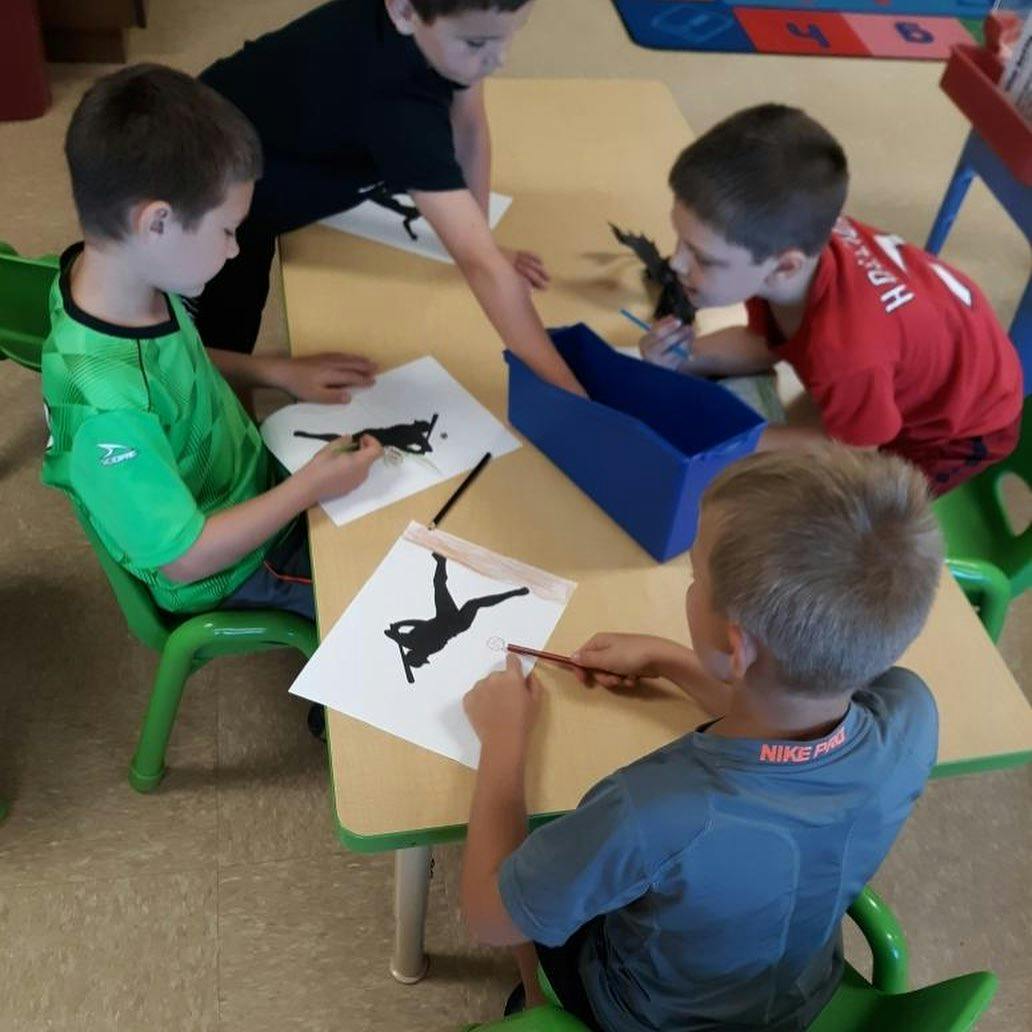 Children drawing at a table