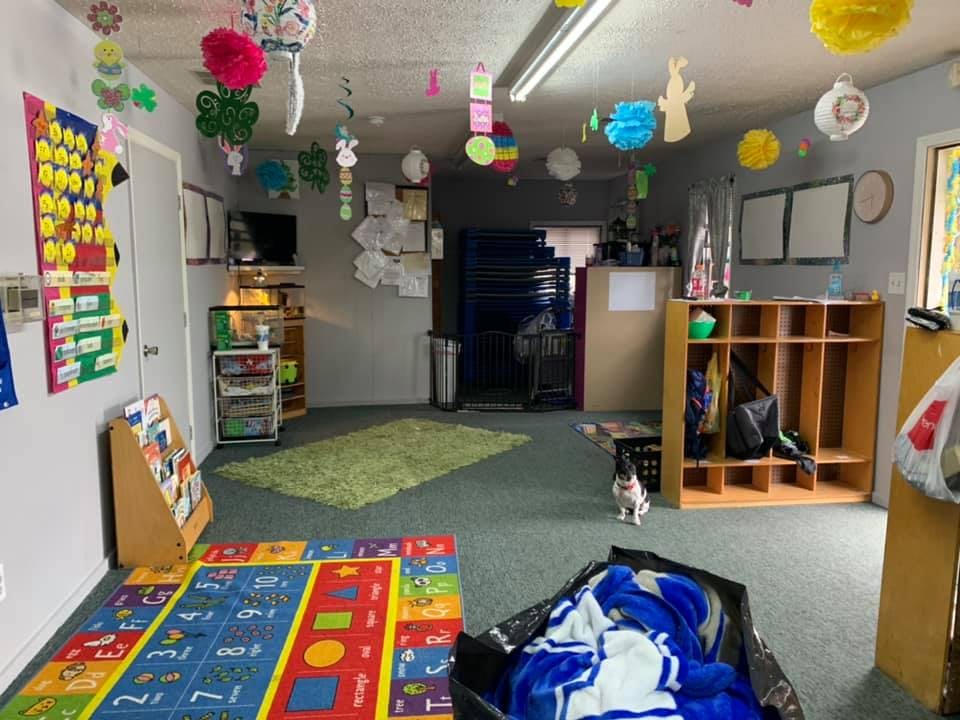 Classroom with colorful decorations, rugs, and storage cubbies
