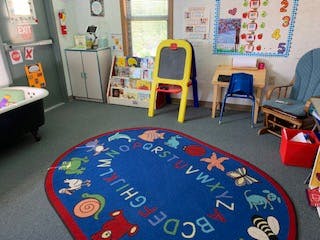 Playroom with alphabet rug and small easel