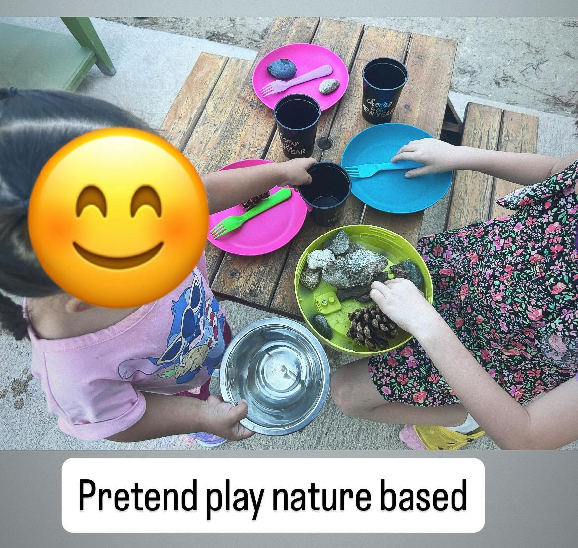 Two children playing with natural elements and dishes on a wooden table