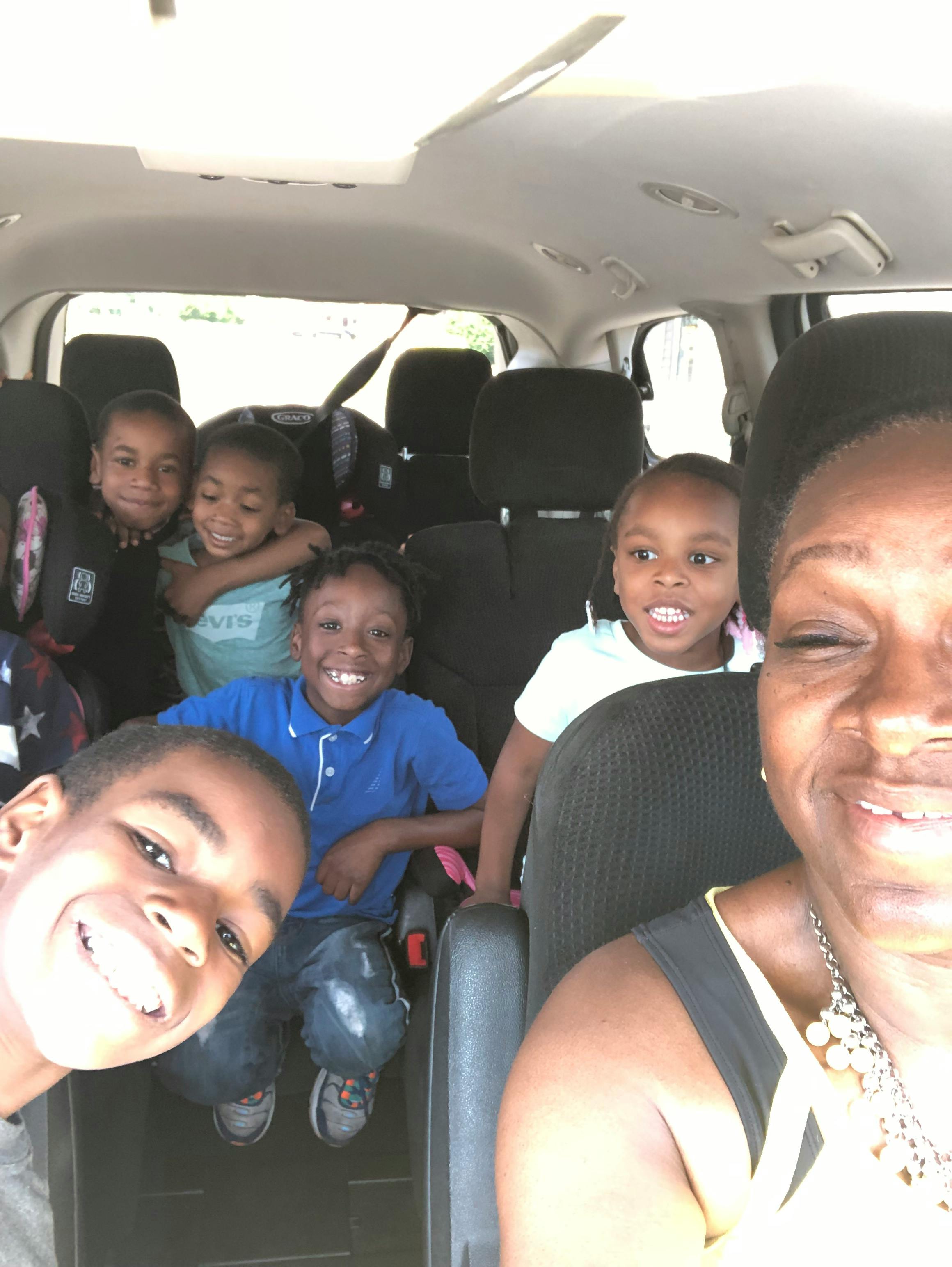 Person and multiple children in a vehicle