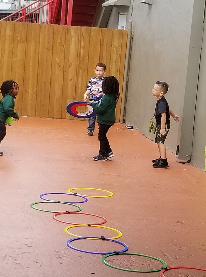 Children playing with hoops and a frisbee