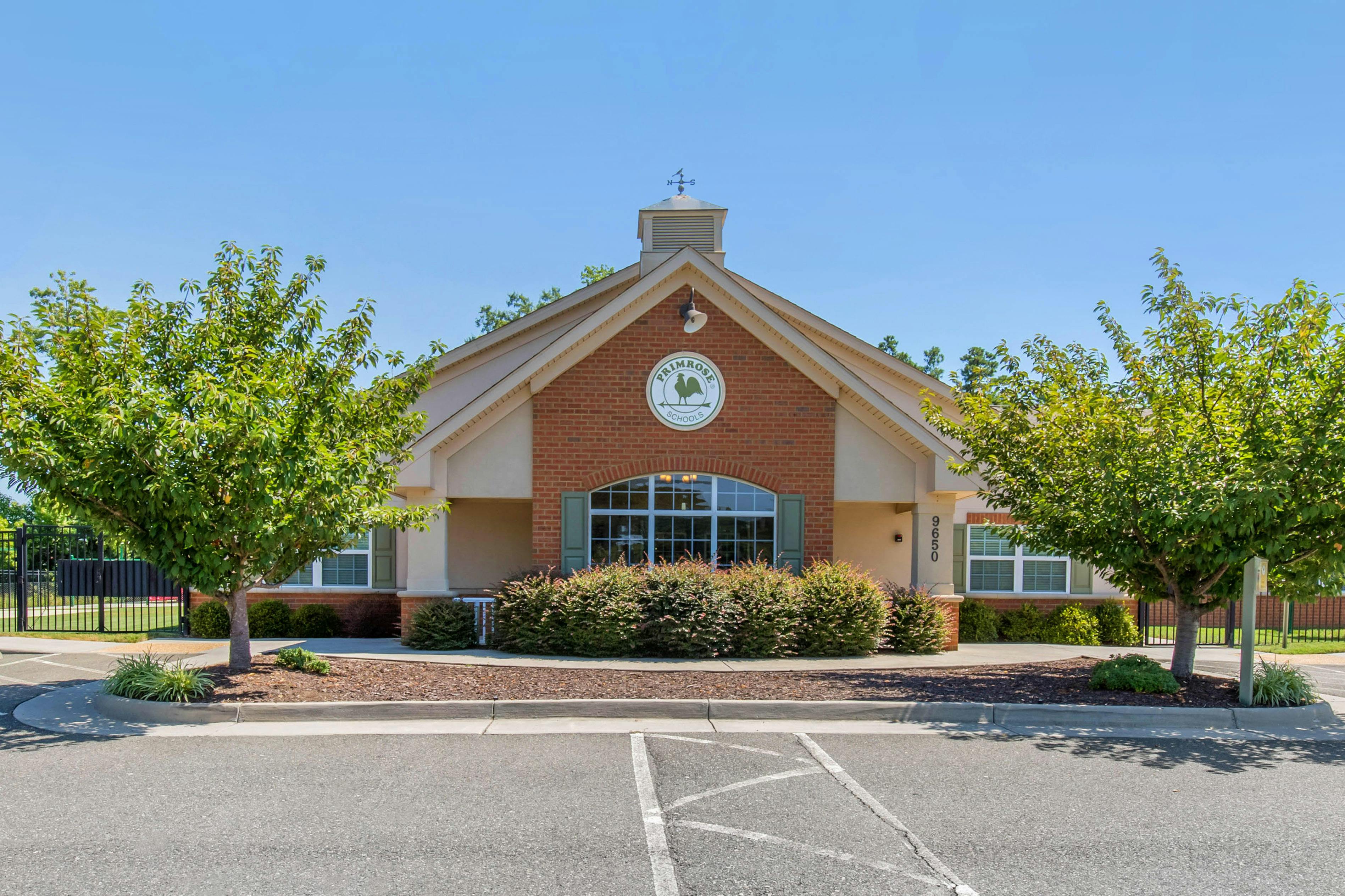 Front exterior of a building with a gabled roof and arched window