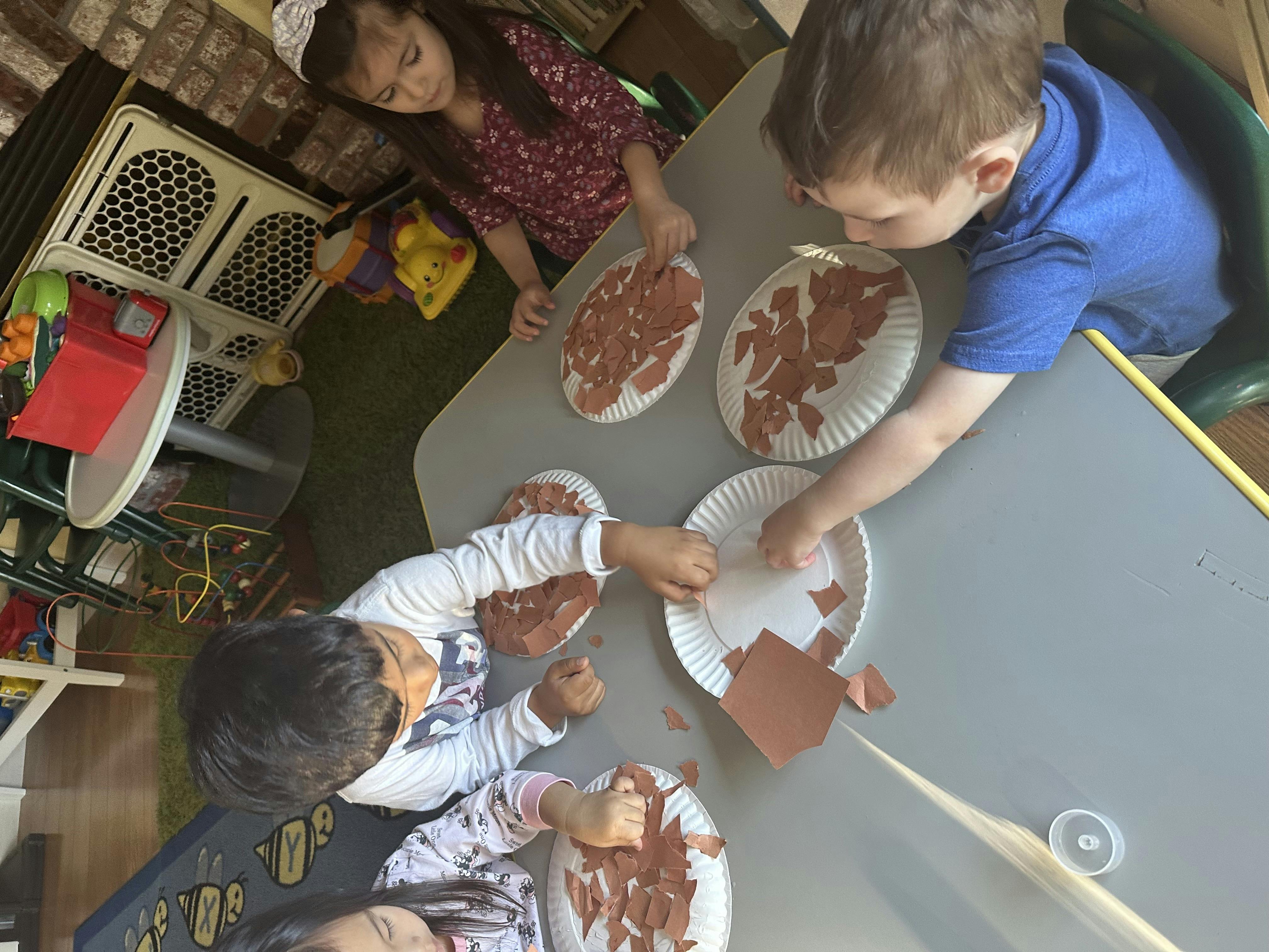 Children doing an art project at a table