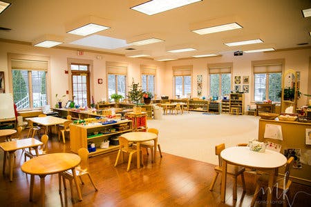 Empty classroom with small tables and chairs
