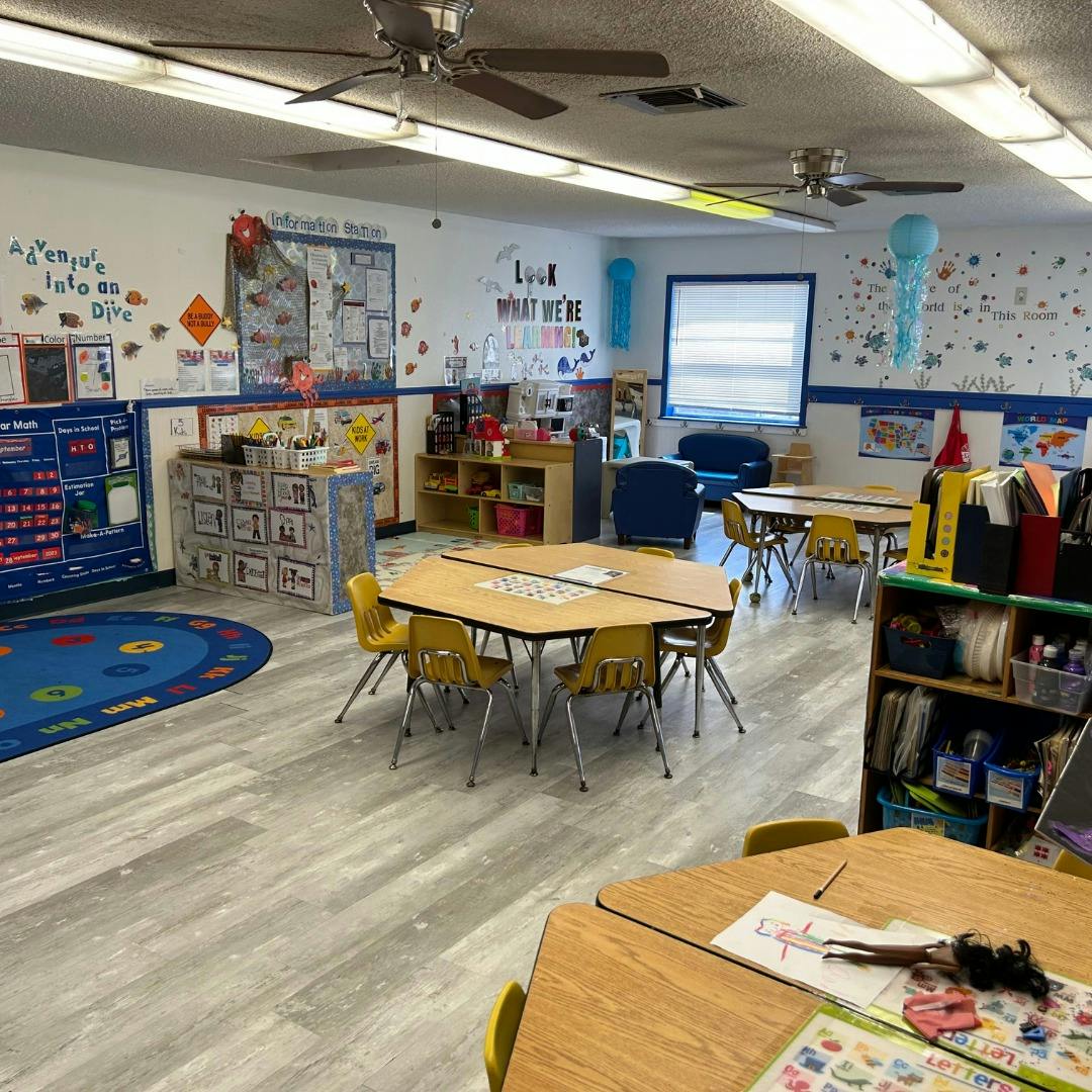 Empty classroom with small tables and chairs
