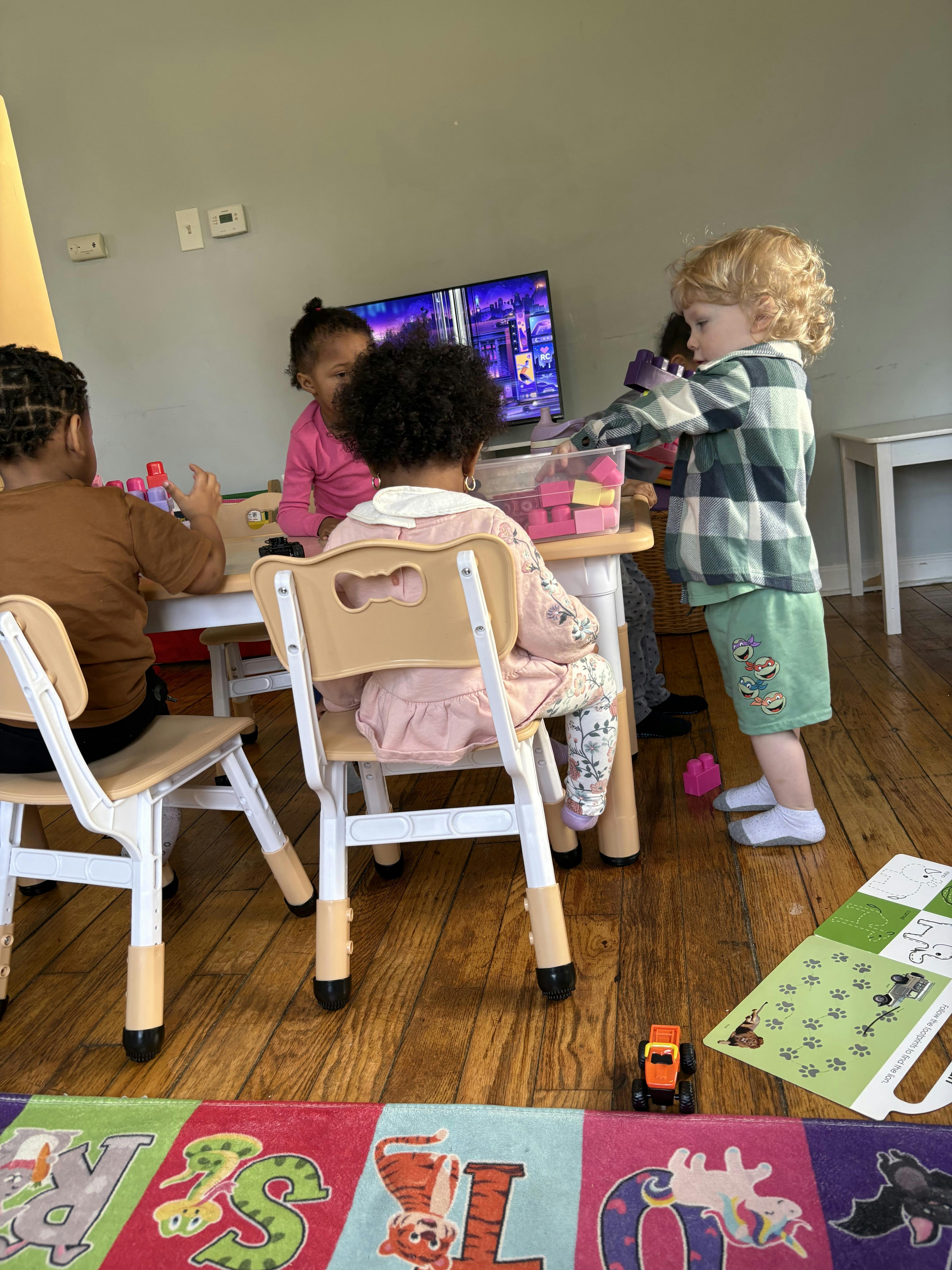 Group of children playing with building blocks at a table