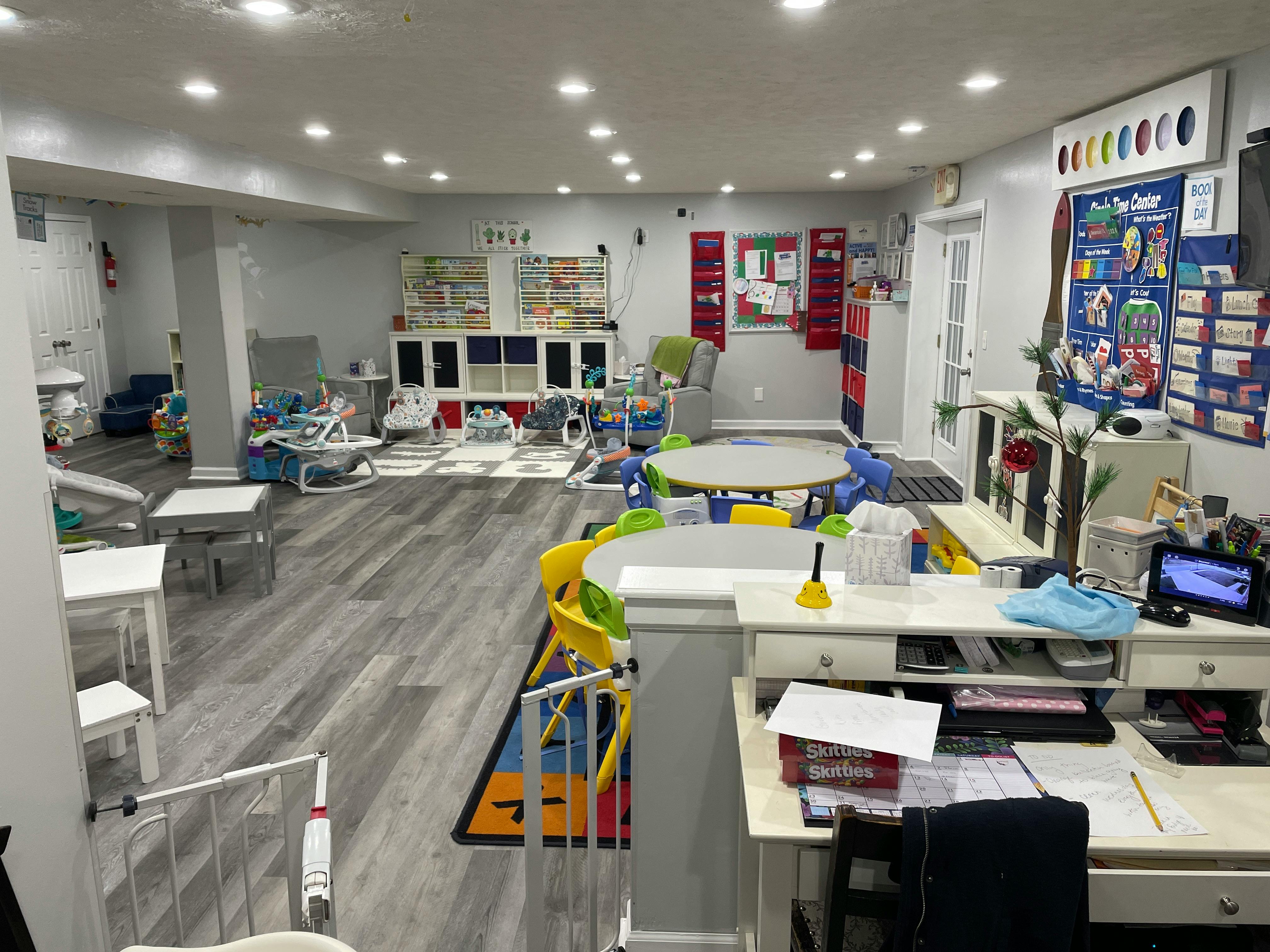 Playroom with small tables and chairs, toys, and learning materials