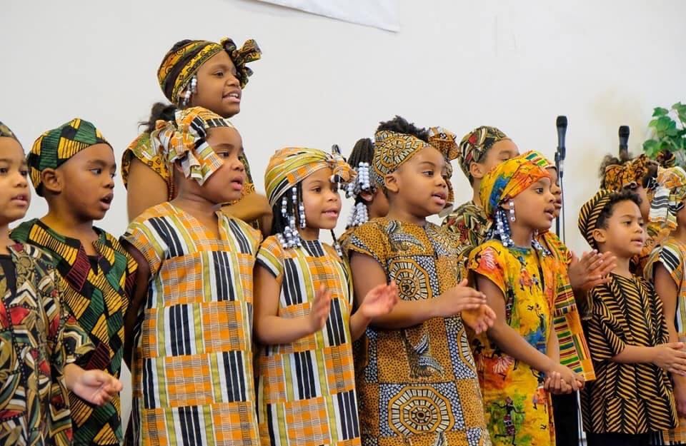 Children in traditional clothing singing