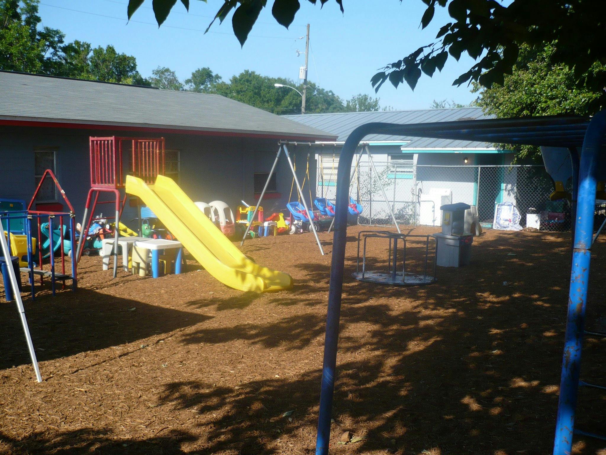 Playground with yellow slide and swings