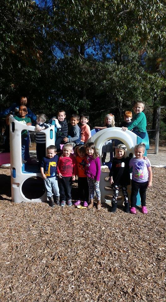Group of children and adults on a playground structure